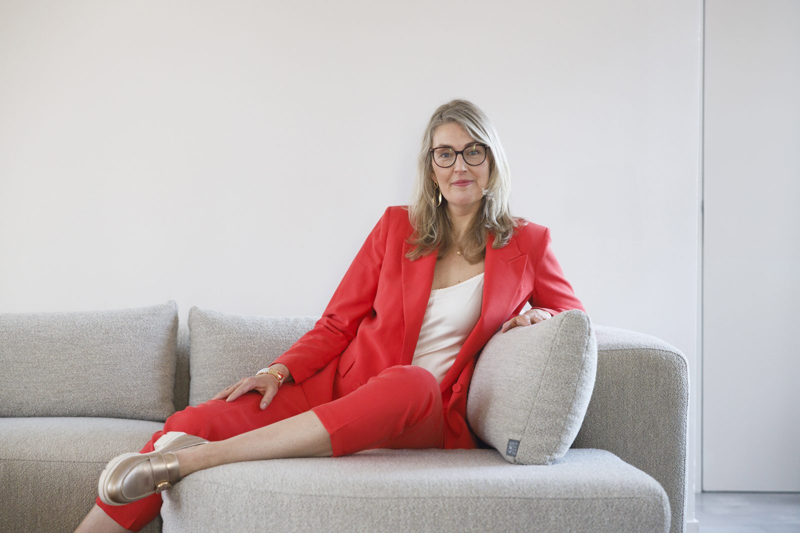 Els Reeuwijk zit ontspannen op een bank, klaar voor een kennismakingsgesprek